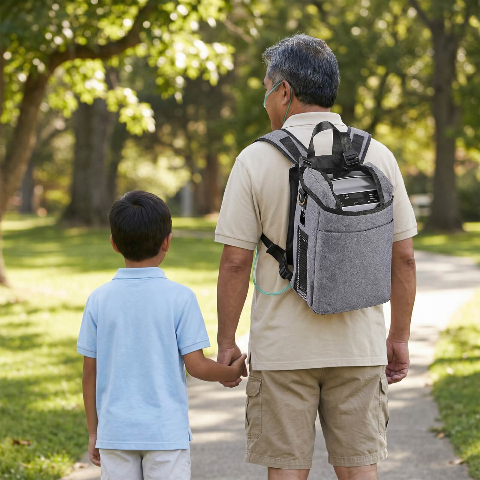 VP-1 portable oxygen concentrator used by an old man during an outdoor walk with a young child.