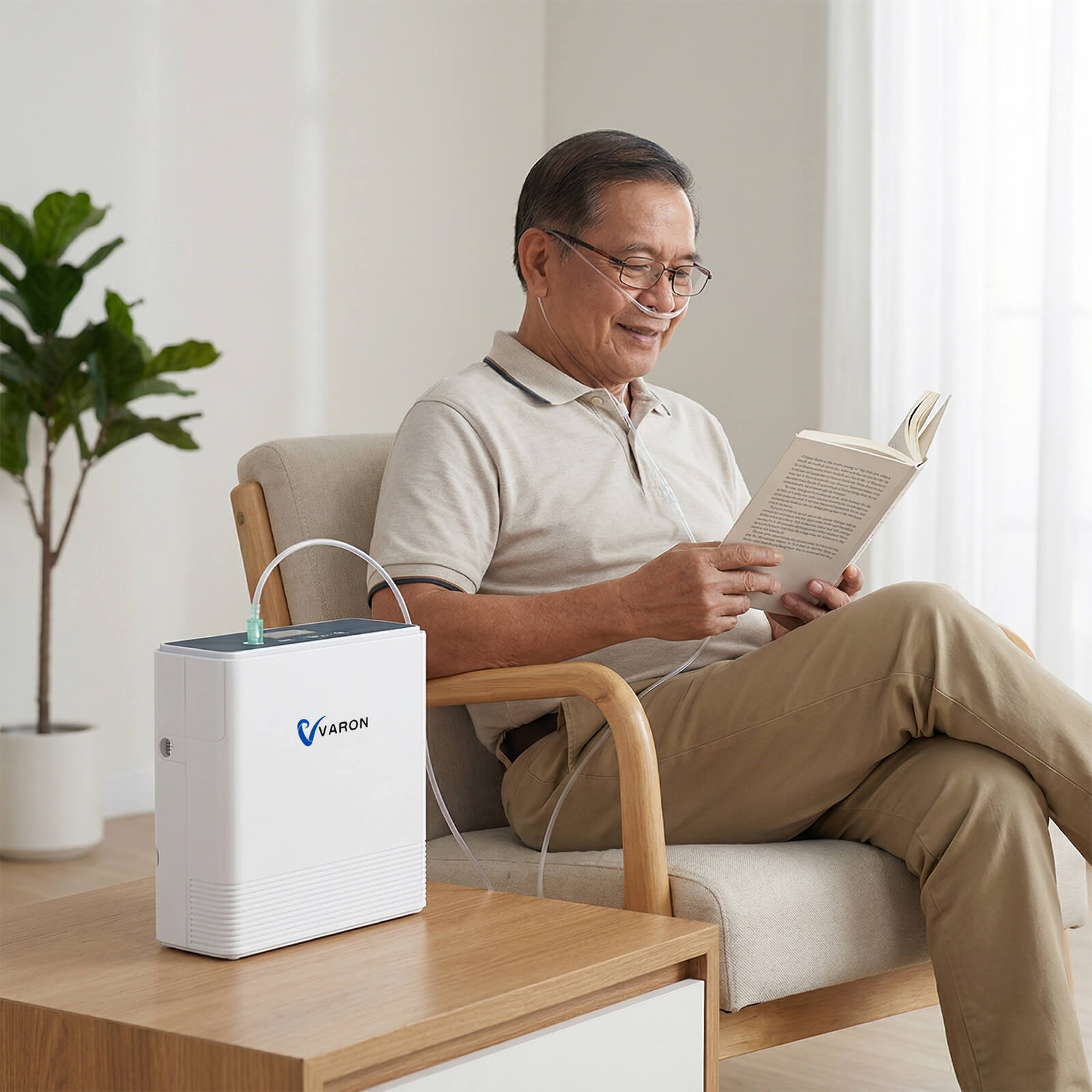 Senior man using a VARON VP-6 portable oxygen concentrator while relaxing and reading at home.